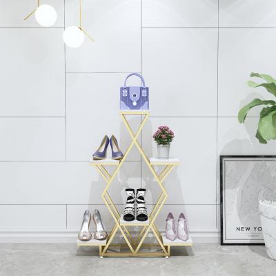 China Stores Retail Customized High End Luxury Interlocking Clothing Store Metal Worktop Display Racks Table Shoes Flower Stand for sale