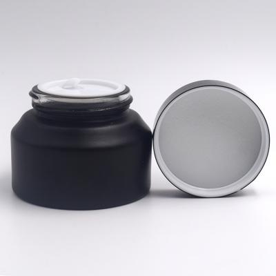 China Black Glass Packaging 15ml 30ml 50ml Skin Care Cream Jar Seal 1oz Cosmetic Matte Cosmetic Jar Jar With Black Cap for sale