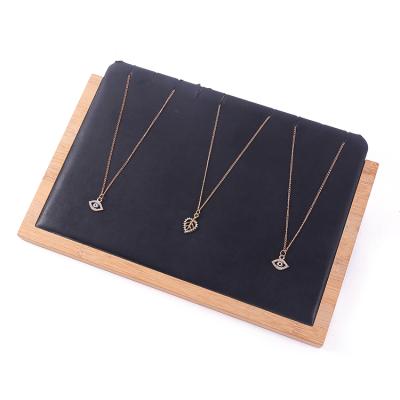 China Fashion Elegance Luxury Simplicity Solid Wood Black Leather Necklace Display Rack Necklace Display Tool Necklace Jewelry Display for sale