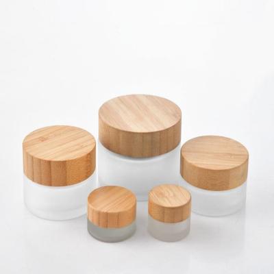 China Personal Care Frosted Clear Glass Jar Bamboo Lid Cosmetic Cream Bottles Glass Packaging Bottles With Wooden Lid for sale