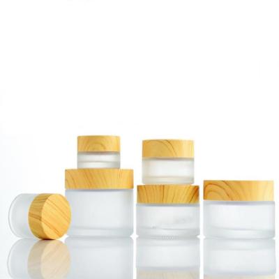 China Personal Care Cosmetic Container With Wood Grain Printing Lid Frosted Skin Care Jar Cream Glass Jar for sale