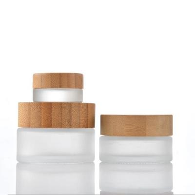 China Hot Selling Cosmetic Frost Eco-Friendly Glass Cosmetic Jar With Bamboo Lid For Eye Cream Face Cream for sale