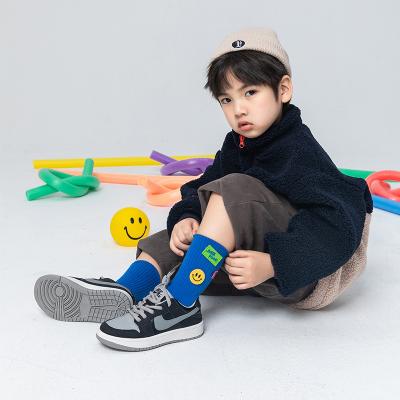 China New Disposable Smile Face Children's Sports Socks Student Middle Tube Socks for sale