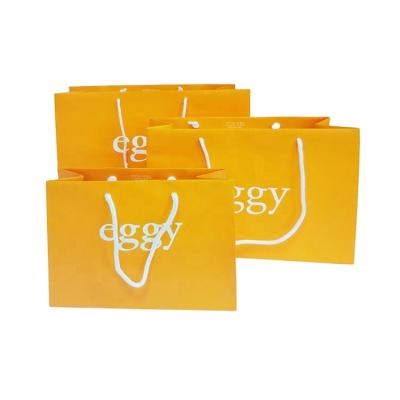 China Recyclable Fancy Customized Orange Printed Luxury Gift Paper Shopping Bag With Handles for sale