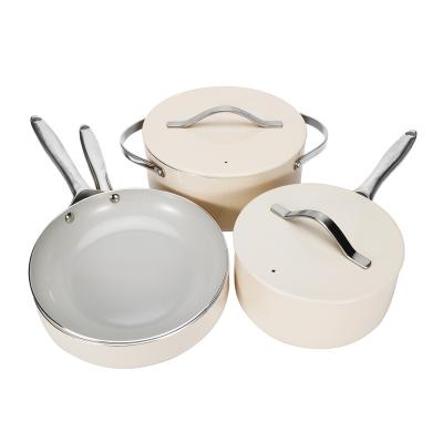 China Press stocked aluminum cookware set with premium ivory white non stick coaitng and stainless steel handle for sale