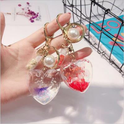 China Popular high quality plastic hand shapped shinny key chain blue star glitter heart liquid key chain for sale