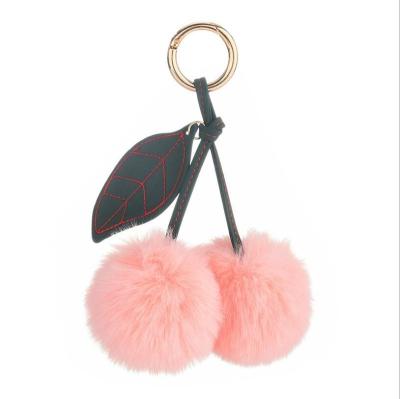 China Keychains for girls Cheap wholesale cute cherry shape leather pompom keychain for bag for sale