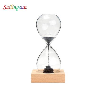 China Safe Classic Wooden Base Food Grade Pyrex Table Sand Glass Ball Clock High Clear Clock for sale