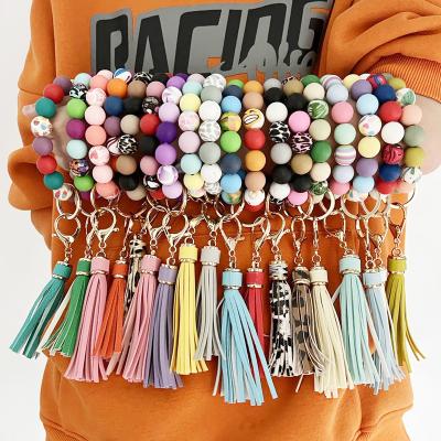 China Newest 2022 FASHIONABLE Silicone Flower Shaped Ball Bead Bracelet Tassel Leopard Leather Print Beaded Key Chain Bracelet Gift for sale