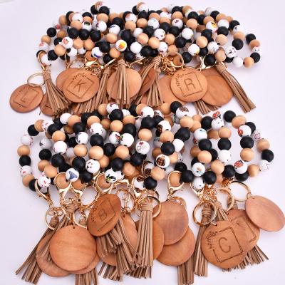 China Wholesale Handmade Printing Bracelet Fashionable Initial 26 Letter Key Chain Bead Tassel Bracelet Party Gift/Wooden Key Chain With Wood Disc for sale