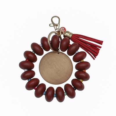 China Hot Selling Party Gift / Wood Beaded Key Chain Bracelet Fashion Design Wooden Disc Beads Bracelet Key Chain With Tassel for sale