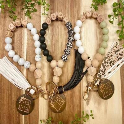 China Monogram Sunflower Leopard Print Silicone Beads Wood MOM Disc Wriselet Key Chain Party Customized Blank Holder Tassel Gift/Bracelet for sale