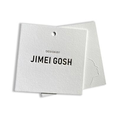 China Viable Cheap Custom Recycled Garment Tag Debossed Brand Paper Card Garment Tags Embossed Logo Swing Garment Tags for sale