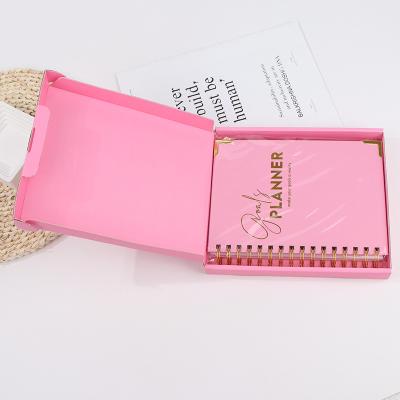 China Pink Hard Cover Planner Hard Spiral Cover OEM ODM Notebook Wellness Goal Weekly Printed Diary Journal With Packing for sale