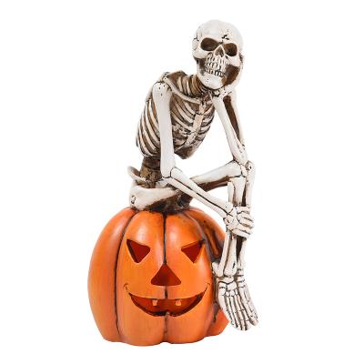 China Halloween Decoration Light Product New 2021 One Set Resin Human Skulls Sits On Pumpkin Led Light For Halloween Decoration for sale