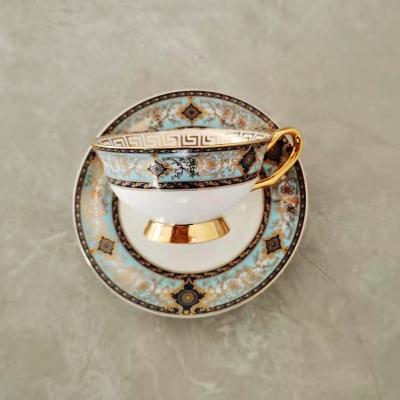 China Sustainable Wholesale Tea Cup And Saucer Fine Bone China With Handmade Gold Handle for sale