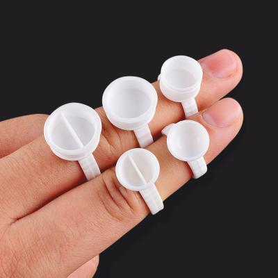 China Disposable Glue and Ring Wick 100Pcs Eyelashes Glue Rings Tattoo Dye Palette Holder Container Eyelash Extension Tool Adhesive Wholesale for sale