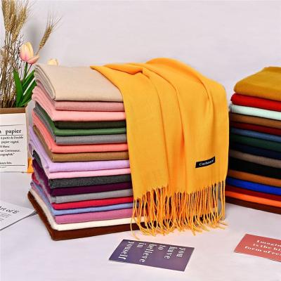 China New autumn and winter solid color scarf fashion tassel European American mid length warm scarf for ladies for sale