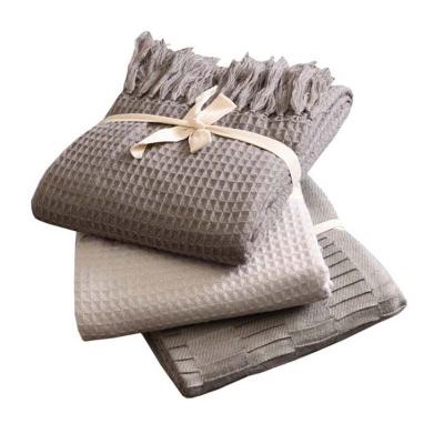 China Solid Color Tassel Waffle Throw Anti-static High Quality Embossed Decorative Knitted Blanket for sale