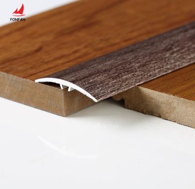 China Modern Wood Effect Aluminum Tile Floor Trims Timber Floor Trim Transition Metal Strips for sale