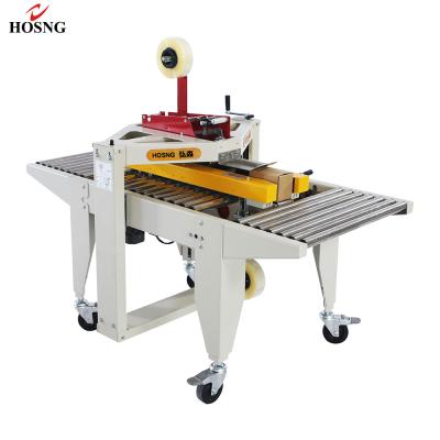 China Portable Food Driven Through Band Packing Machine Cardboard Carton Box Sealing Machine for sale