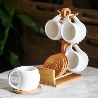 China Sustainable Coffee Mug Set 4 6 Oz With Stand And Saucer Wood Serving Ceramic Cup Sets Turkish Coffee Cup For Home Office White for sale