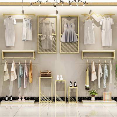 China Simple Fashion Display Rail Rose Gold Metal Clothes Wall Boutique Display Stand Racks For Shops for sale