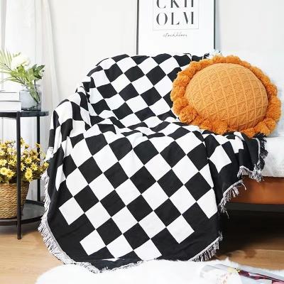 China Anti-pilling MOQ 50PCS Woven Throw Blanket Checkerboard Decorative Sofa Tassel Blanket Custom Tapestry for sale