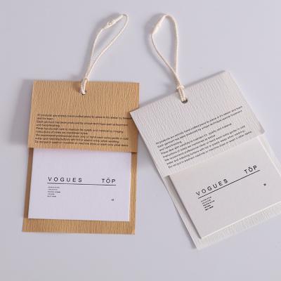 China Sustainable Custom Logo Paper Tags Recyclable Brand Name Garment Hang Tags For Clothes for sale