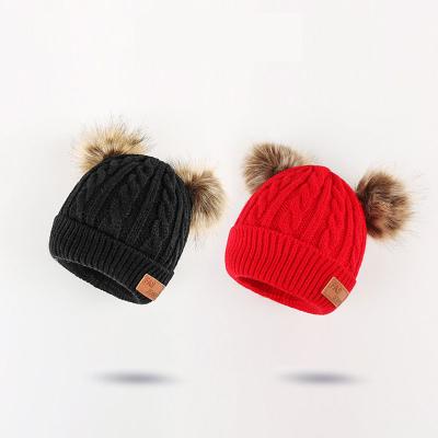 China COMMON Two Color Fur Poms Winter Sheer Beanie Fleece Lined Skull Cuff Beanie Knitting Hat With Pom for sale