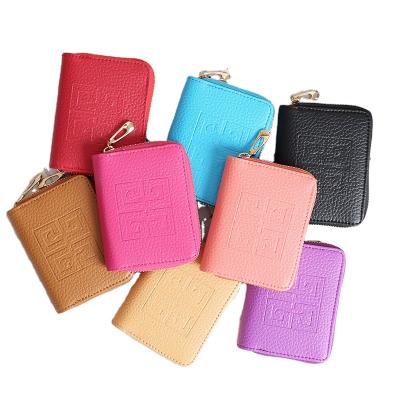 China Waterproof short ladies pinch wallet wallet Korean fashion zipper pure color lychee skin clutch bag embossed square small bag for sale