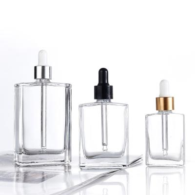 China Cosmetic 5ml 10ml 15ml 30ml 50ml 100ml Square Essential Oil Shoulder Clear Glass Flat Dropper Bottle for sale