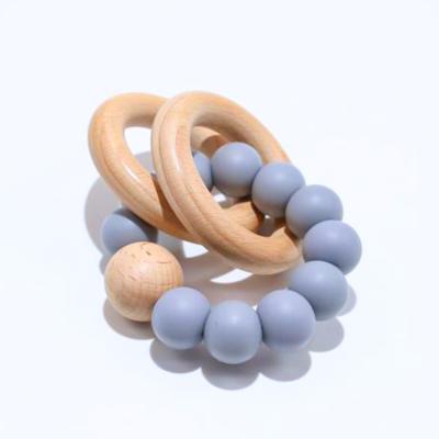 China Soft Organic Wooden Toy Baby Teether Bracelet Natural Ring Teething Grasping Toy Silicone Beads Ratchet for sale