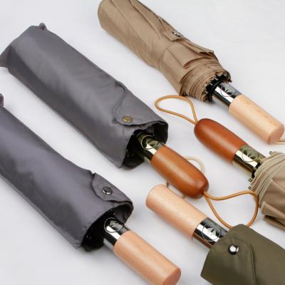 China Black Travel Handle Foldable Umbrella Windproof Automatic Open Wooden UV Proof Umbrella for sale