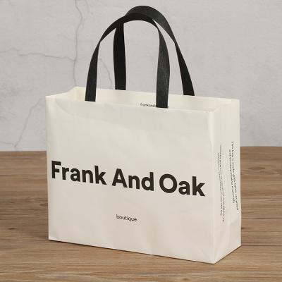 China Biodegradable Simplicity Fashion White Custom Logo Kraft Paper Shipping Packaging Bags For Clothing for sale