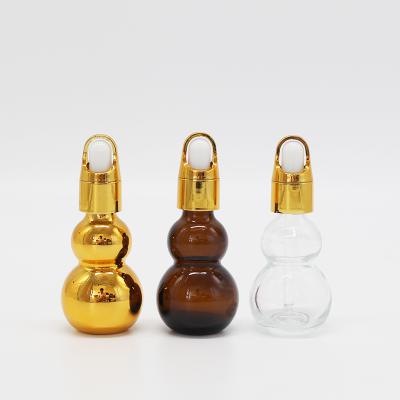 China Custom Empty UV Gold Electroplating Gourd Personal Care Perfume Essential Oil Glass Dropper Bottles 10ml 15ml 20ml With Gold Cap for sale