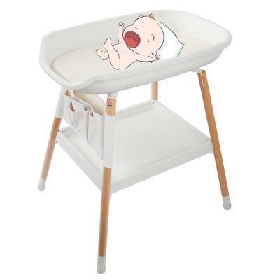 China Modern Diaper Baby Diaper Changing Table with Pure Wooden Cotton Pad Baby Crib Dresser with Pockets Newborn Massage Tables Care Station for sale