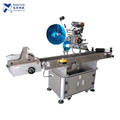 China NY-817F Self Adhesive CLOTHING Sticker Label Applicator For Pouches Bags With Page Conveyor System for sale