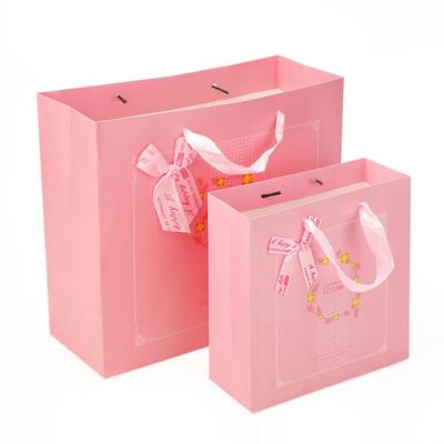 China Low MOQ New Materials Recycled Luxury Ribbon Bowknot Advertising Paper Shopping Bag With Customize Logo for sale