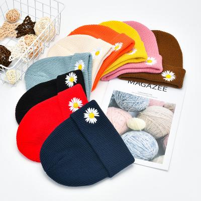 China Fashion COMMON Winter Warm Windproof Knitted Hat With Embroidery Daisy Designer Beanie Hat For Girls Women Decorate for sale