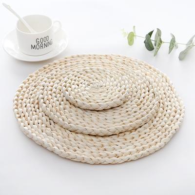 China Japanese Style Eco-Friendly Woven Rattan Place Mats Around Straw Placemats Table Mats And Braided Coasters for sale