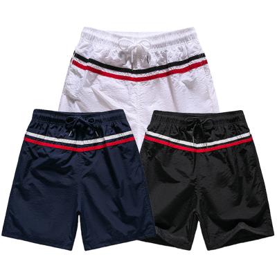 China Hot Selling QUICK DRY QUICK DRY Striped Color Blocking Summer Casual Beach Shorts 4xl Plus Size Breathable Quick Dry Men Sweat Swim Shorts for sale