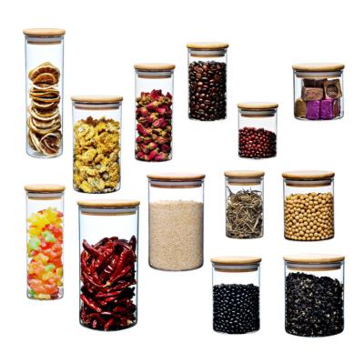 China Best Mini Cylinder CANDY Storage Glass Jars Small Cheap Airtight Food Candy Containers With Wooden Top Lid for sale