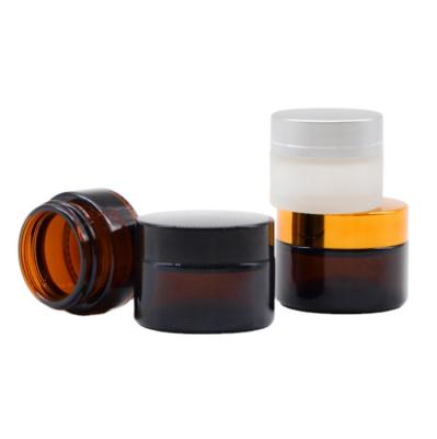 China Personal Care Cosmetic Cream Jars 5g 10g 15g 20g 30g 50g 100g 1oz 2oz Amber Glass Jar With Gold Silver Black Cap for sale