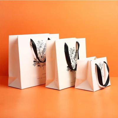 China Recyclable Custom Luxury Garment Gift Paper Shopping Bags With Logo Printed for sale