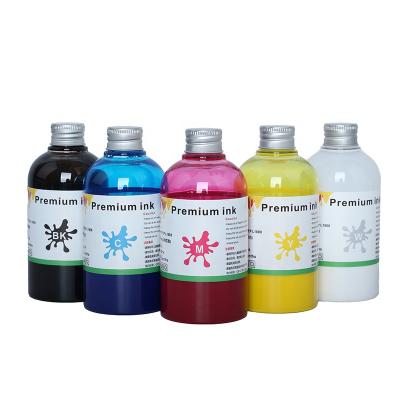 China Vivid color non clog bulk white CMYK DTF ink PET film transfer ink for L1800 4720 1390 i3200 L805 printer ink for sale