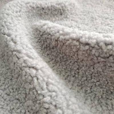 China Factory custom warm knitting 100% polyester softshell granule lamb fleece fabric for textile garment for sale