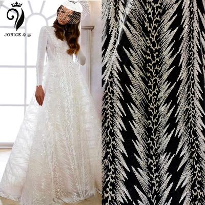 China Viable White Shiny Custom Luxury Wedding Gown Dresses Embroidery Beads Bridal Sequin Lace Fabric for sale