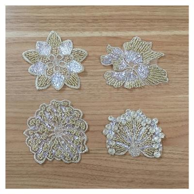 China Viable Hot Sale Low Price Flower Design Gold Apparel Patch For Dress for sale