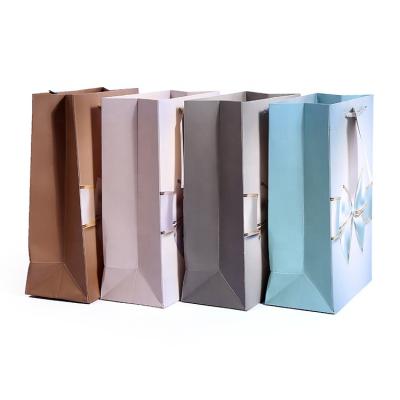 China Euro Recyclable Customized Printed Kraft Paper Gift Bags With Bowknot Luxury Boutique Gift Bag Shopping Packaging for sale